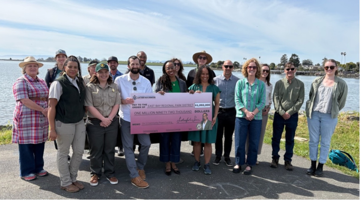 Congresswoman Simon stands with East Bay Regional Park District Staff Holding a funding check