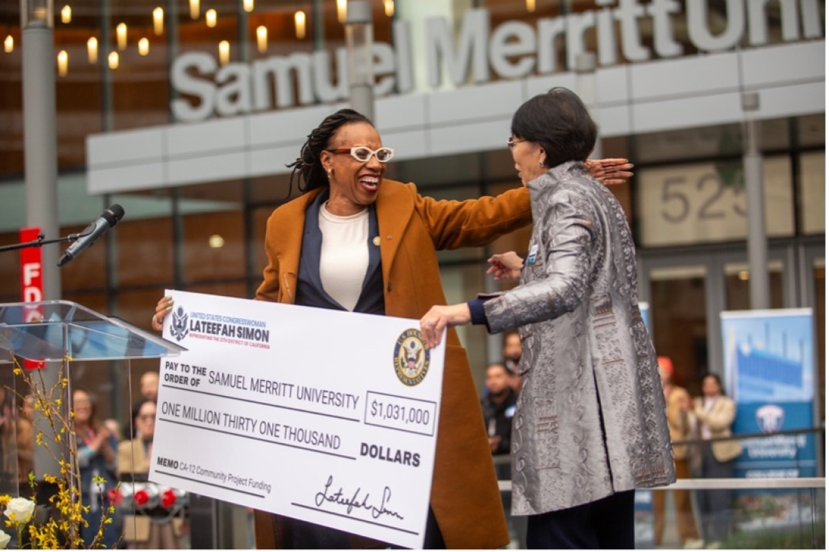 Congresswoman Simon presents a big check to President Wang